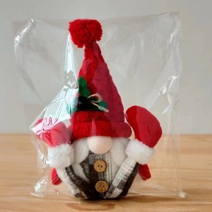 Detail of Nordic Christmas gnome featuring red knitted hat and faux fur beard in packaging
