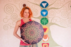 Bohemian Shamanic Drum with mandala art patterns held against a tree of life backdrop
