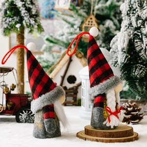 Gnome ornaments with red plaid hats and sequin stars on a snowy festive background