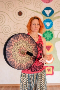 Detailed shot of shaman frame drum with mandala patterns and a black drumstick