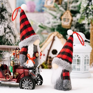 Detail of plush Christmas gnomes featuring red and black buffalo plaid and faux fur texture