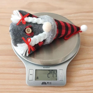 Close-up of a 27.4g Christmas gnome plush with red plaid hat and braided beard details