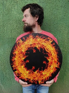 Bohemian percussion festival drum with vibrant orange fire pattern on black surface