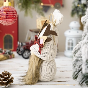 Knitted Christmas gnome doll with brown felt antlers and a festive red plaid bow