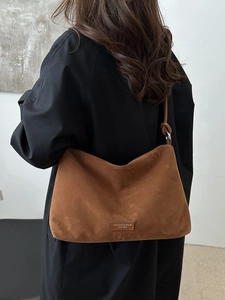 Brown suede shoulder bag for women with leather straps and decorative logo tag
