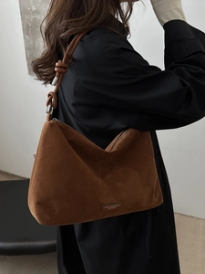 Brown suede shoulder bag with knot strap detail and fashion leather tag for women