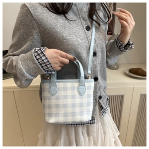 Blue and white gingham tote bag featuring leather handles and gold-tone hardware detail