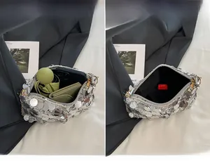 Detailed interior of silver sequin shoulder bag showing capacity for phone and umbrella