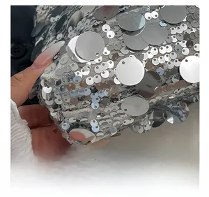 Close-up of precise stitching and shiny silver sequins on the stylish handbag detail