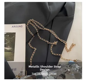 Detail of golden metal chain strap and silver sequins on large capacity shoulder bag