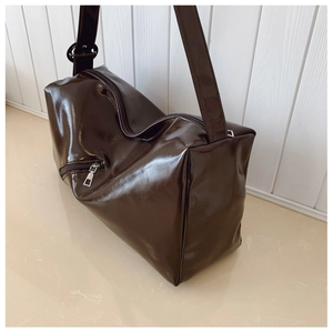 Detail view of large dark coffee tote bag with glossy finish and side zipper pocket