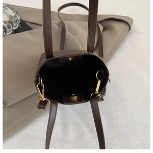 Detail view of retro tote bag interior with magnetic closure and golden hardware