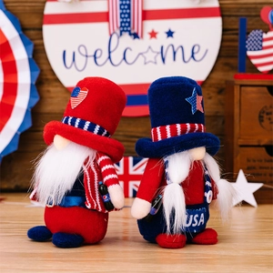 Detail of two patriotic July 4th gnomes with USA motif on a wooden welcome background