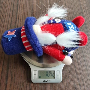 Detail showing an Independence Day gnome being weighed on a scale at 104.2g