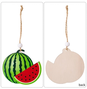 Detail of wooden watermelon ornament with vibrant painting, jute rope and white bead