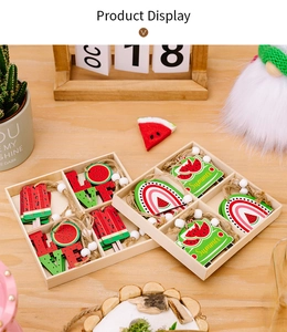 Detail of wooden summer watermelon hanging ornaments with jute rope and white beads in a tray