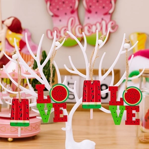 Detail of wooden watermelon charms with LOVE letters and summer patterns for home decor