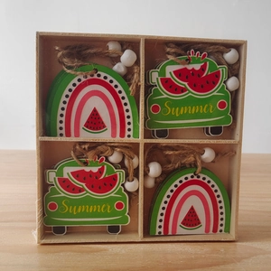 Detail of summer watermelon wooden pendants set with rustic beads in a wooden box
