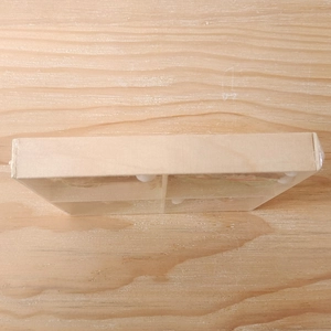 Detail of four-compartment wooden storage box with clear lid for summer watermelon ornaments