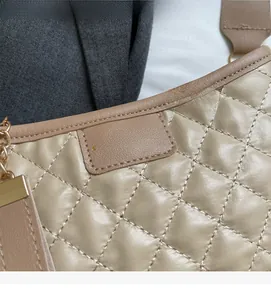 Detail of khaki quilted leather texture with gold chain and fashion embroidery patch