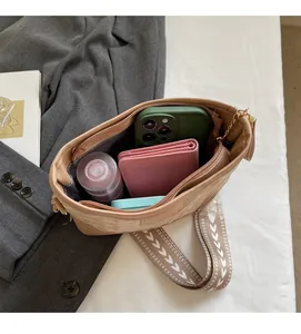 Interior view showing the large storage capacity of a beige quilted crossbody bag