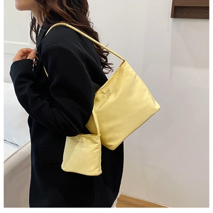 Detail of bright yellow shoulder bag with matching coin pouch on black blazer jacket