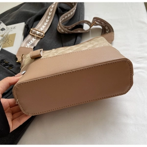 Detailed close-up of khaki quilted crossbody bag featuring a jacquard patterned strap