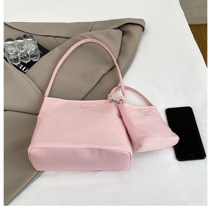 Detailed view of pink nylon handbag and small pouch accessory set for stylish women
