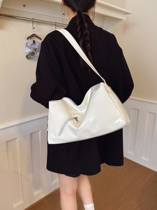 Minimalist white high-gloss large hobo shoulder bag shown on model in urban interior