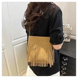 Detail of khaki suede fringe shoulder bag showing long tassels and shoulder strap