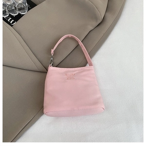 Close-up of pink nylon mini handbag with elegant 'Enjoy Life' embroidery detail