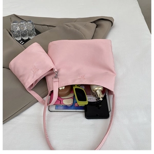 Pink nylon tote bag set showing large capacity with internal compartments and small pouch