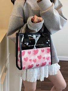 Translucent heart print tote bag with pink canvas base and black handles for women