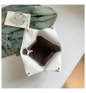Top view of star-shaped white PU tote bag featuring brown fabric lining and zip closure