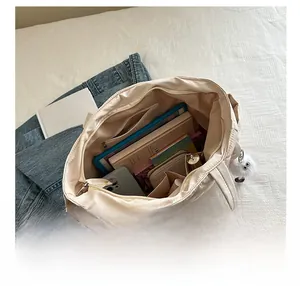 Interior view of quilted tote bag showing large capacity for tablet and daily items