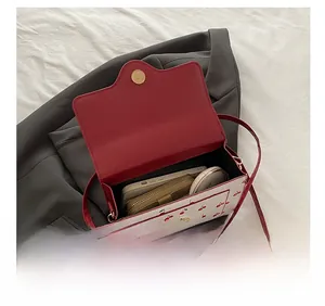 Interior view of cherry print crossbody bag showing space for phone and makeup