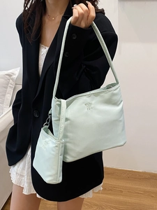 Mint green nylon shoulder bag set with small pouch shown on a fashion model