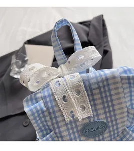 Detail of blue plaid backpack featuring white lace bow and fashion patch decoration