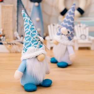 Detail of nautical gnomes with knitted hats and seashells in a beach themed setting