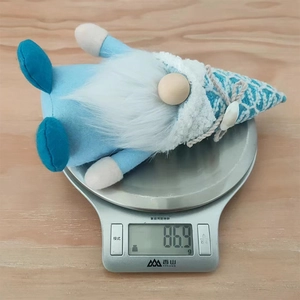 Close-up of ocean-themed gnome plush on a scale showing a weight of 86.9g