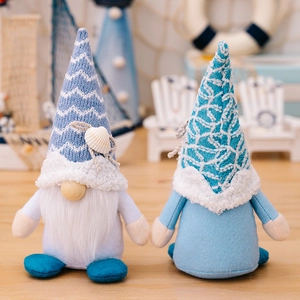 Pair of nautical themed summer gnomes with blue knitted hats and shell decorations