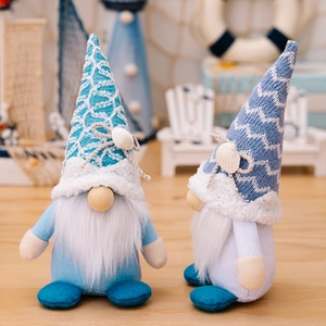 Pair of nautical themed summer gnomes with knit hats and shells on a wooden base