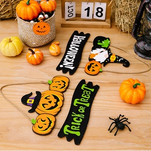 Detail of wooden Halloween gnome and pumpkin ornaments with Trick or Treat hanging signs