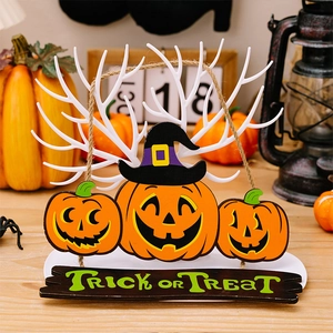 Macro detail of white antler jewelry rack with pumpkin accents and Trick or Treat sign