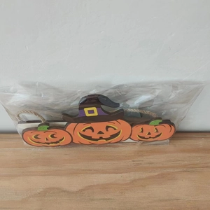 Three linked Halloween pumpkin ornaments with witch hats made of wood for party decor