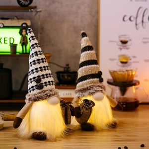 Detail of coffee gnome with glowing warm LED lights and knitted hat with coffee bean accents