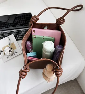 Macro detail of spacious brown pebbled leather tote interior with daily essentials