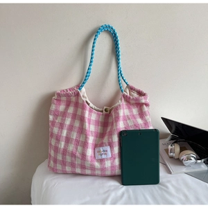 Pink plaid tote bag detail showing large capacity holding a tablet and daily essentials