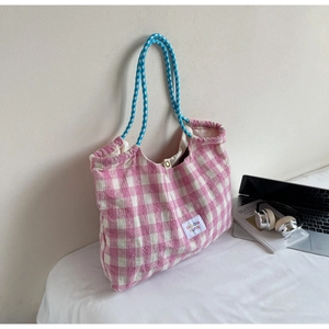 Detail view of pink plaid cotton tote bag with blue rope handles and magnetic closure