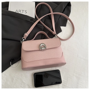 Detail showing the pink woven and smooth leather textures with a silver metal lock